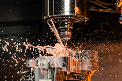 CNC machining centre drilling steel and using metal working flui
